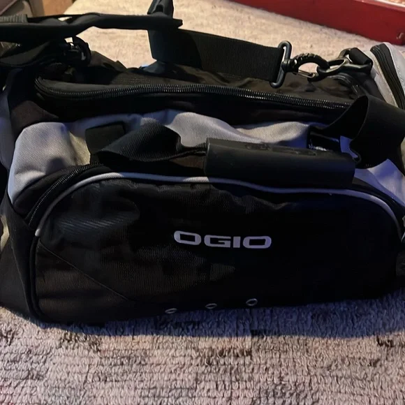 New OGIO sports illustrated black and gray duffle bag with shoulder strap.